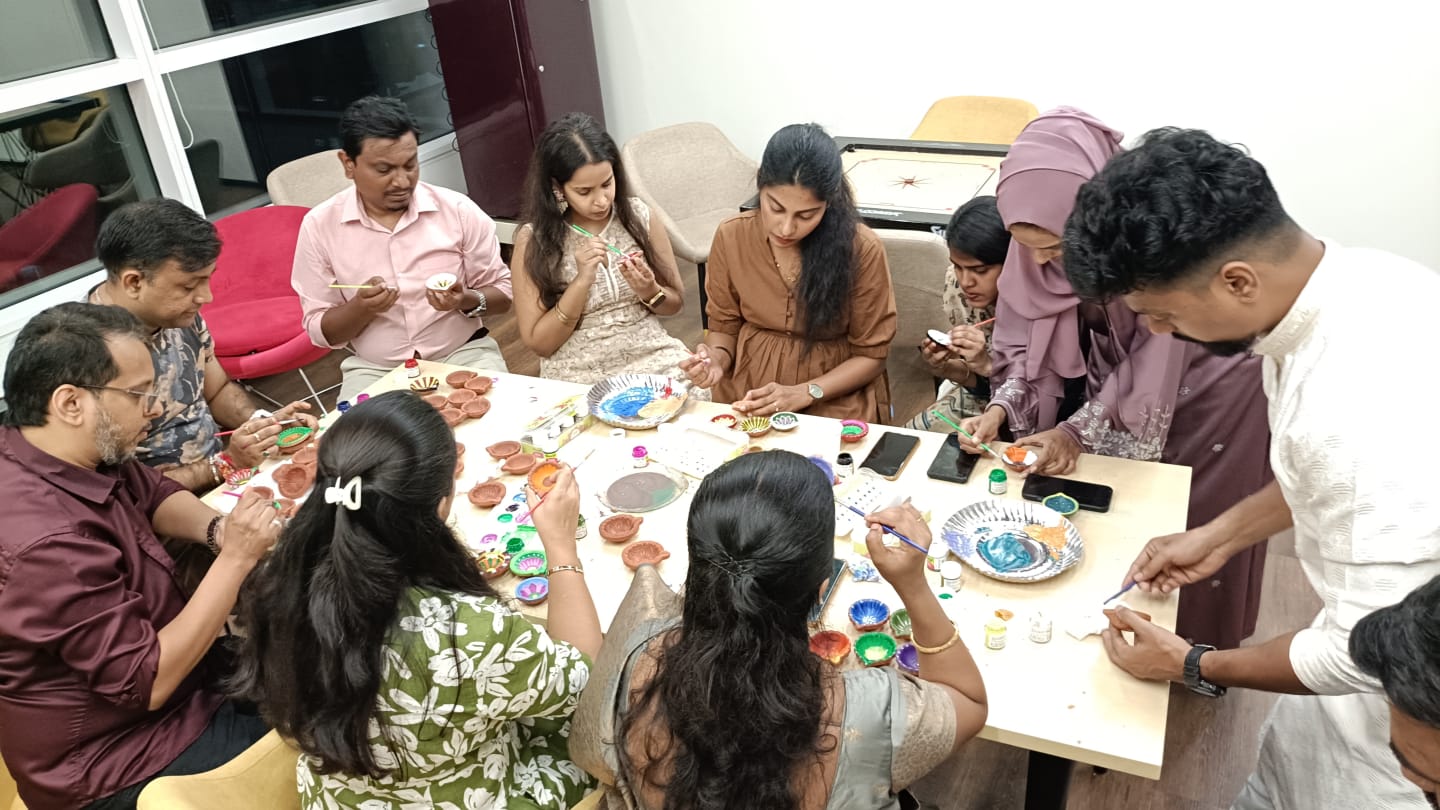 VML Enterprise Solutions Mumbai employees celebrating Diwali by painting diyas.