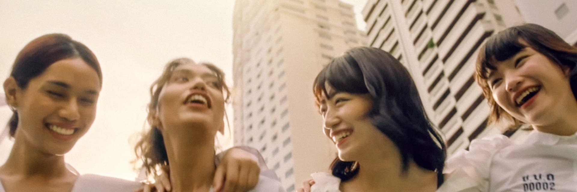 four women in front of a skyscraper skyline