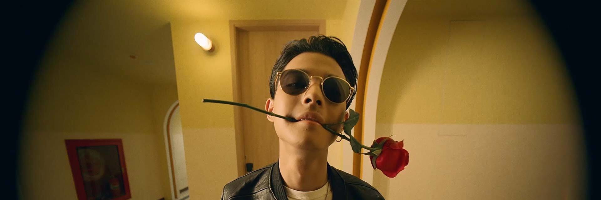 guy with red rose in his mouth