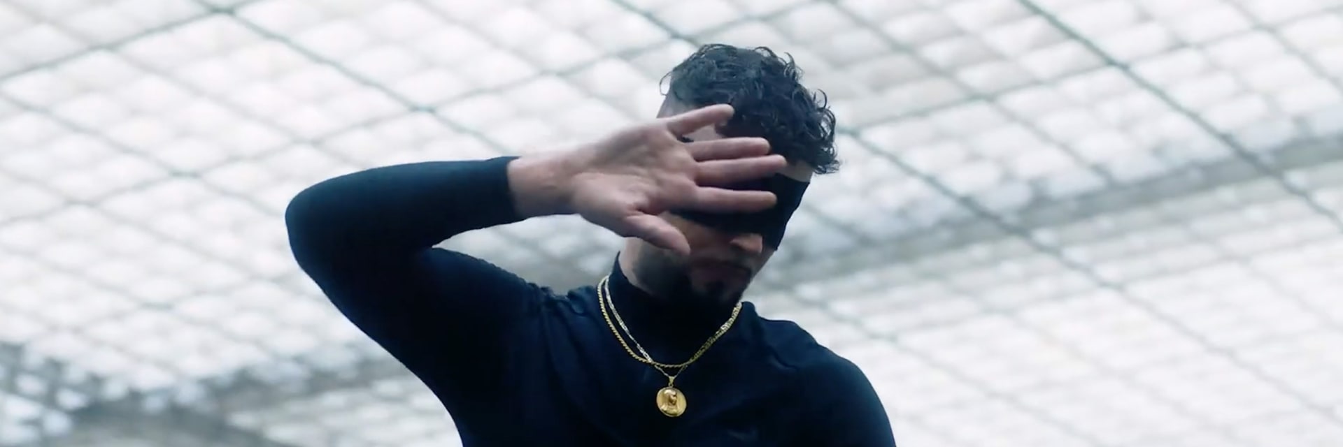man with his hand in front of his face