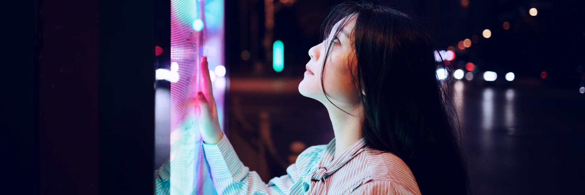 Woman looking at a screen outside large