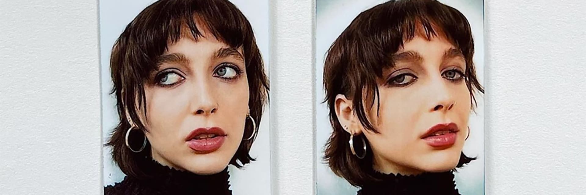 A woman with fair skin and dark, short hair is pictured in two photographs taped to a wall. On the left, she rolls her eyes to the left of the image. On the right, she looks into the camera with her head tilted to the side.