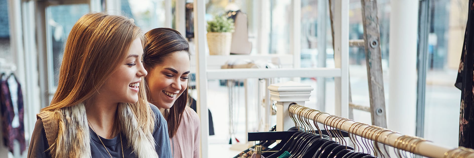 Two women smiling while shopping