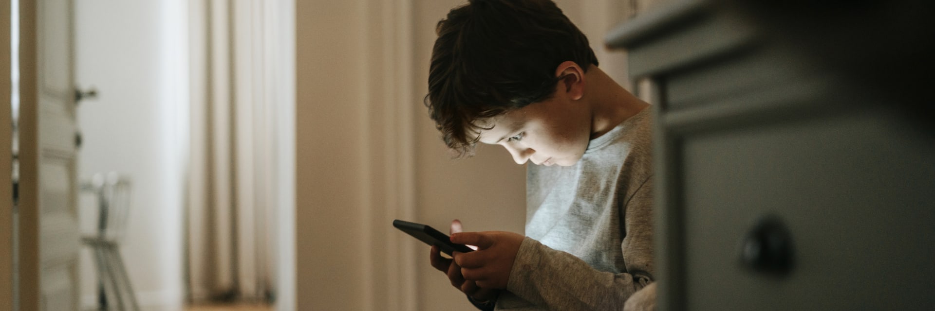 Young boy looking at phone