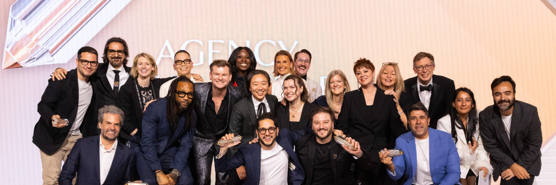 This image shows a group of VMLers posing on stage at an event for "The One Show Awards" by "The One Club for Creativity."