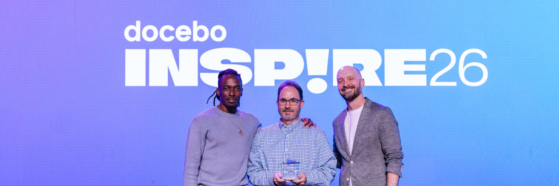 Rich Schmick and Marve Afolayan from VML accepting the Best Employee/Talent Development Program award for the Open Everydai initiative at the Docebo Inspire 2026 Conference in Miami.