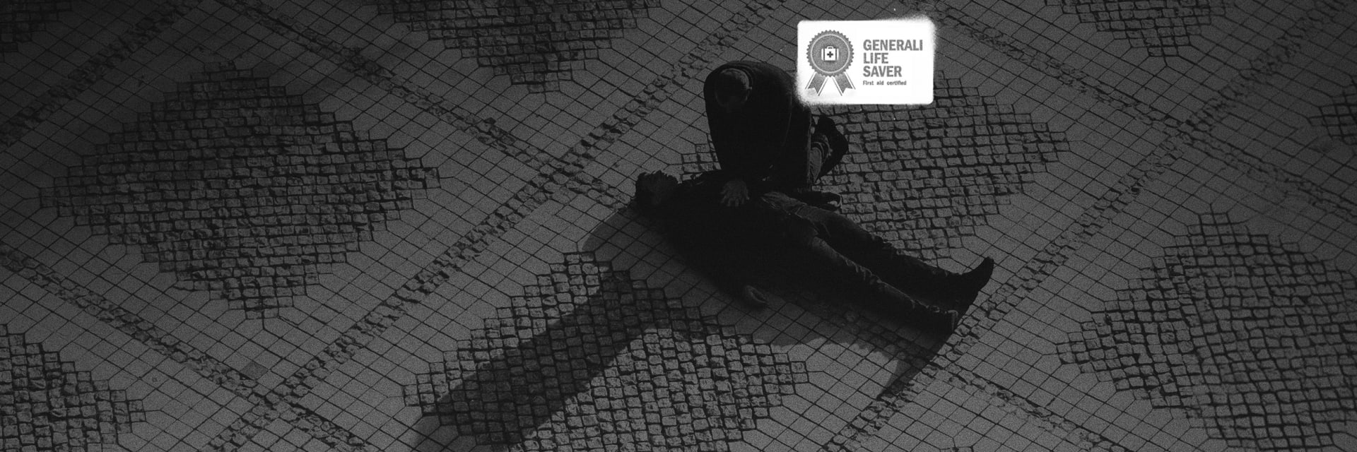 Image of a cartoon person laying in a road with another cartoon person administering life saving care.