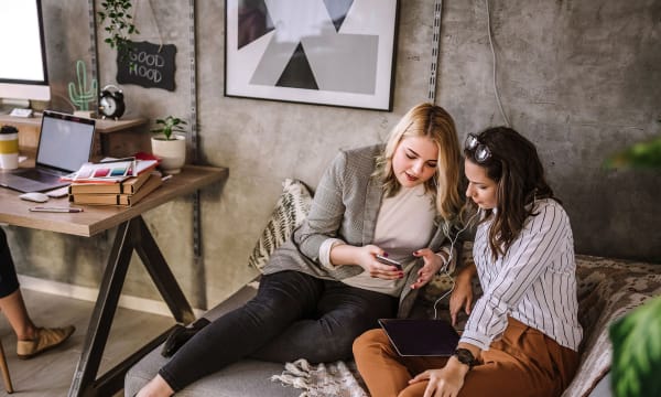 two women on a couch in a living room