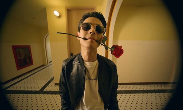 guy with red rose in his mouth