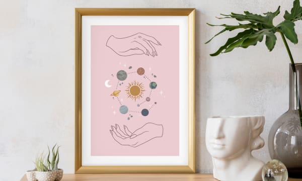 Framed illustration of hands holding the solar system
