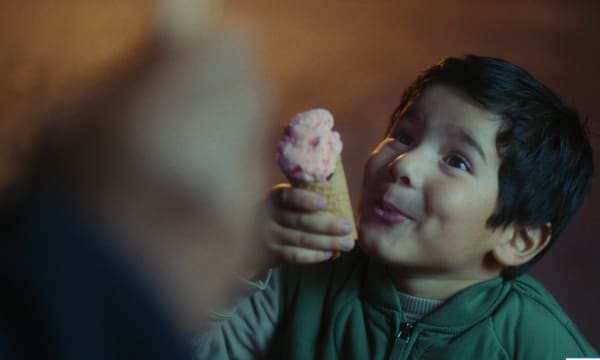 Screen grab of Exide's ad - little boy enjoying ice cream with his grandad
