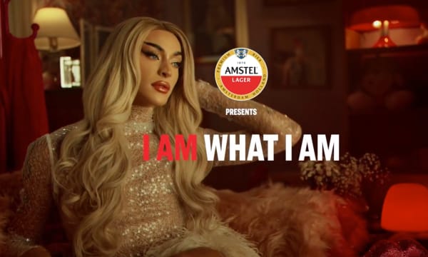 man with long hair and lipstick, Amstel logo