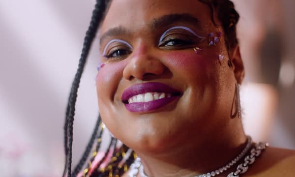 Person smiling with purple lipstick