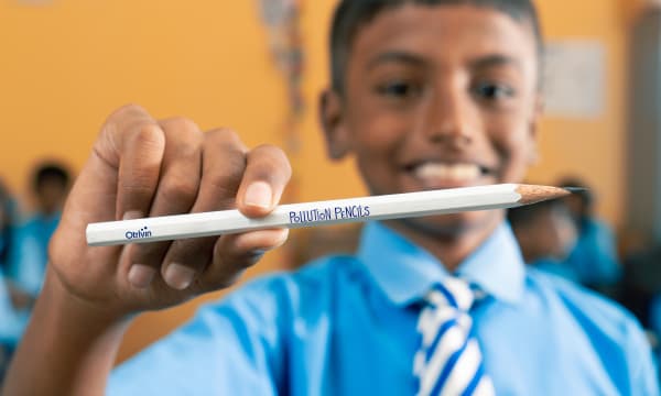 Student Holding Pollution Capture Pencil Smiling