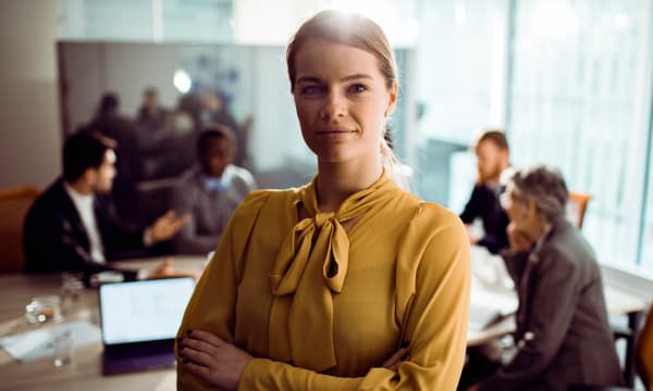 Woman in a yellow blouse in a meeting room