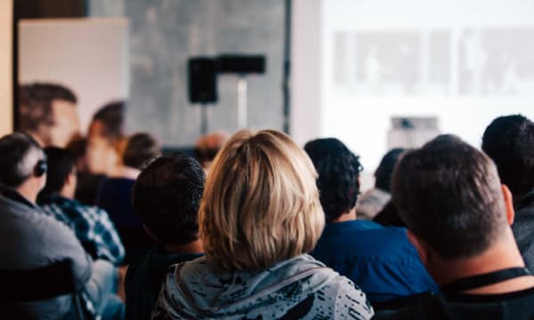 Audience looking to the front of a room