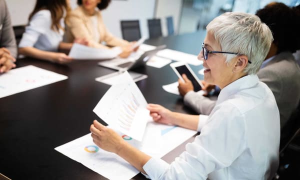 Woman looking at graph analytics at a desk