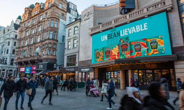 Billboard in Leicester Square with 'Unbeanlieveable' slogan and range of Heinz Beanz products