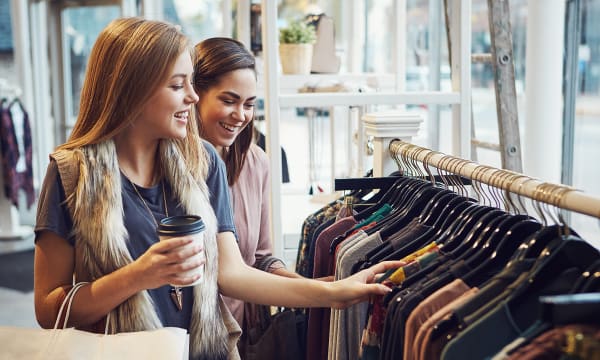 Two women smiling while shopping