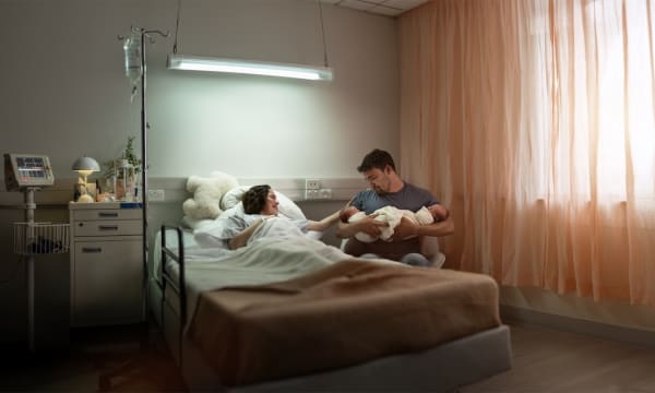 A man and woman welcome their newborn baby into the world at the hospital
