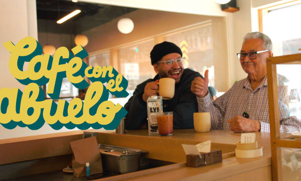 Two Latino men eating in a cafe