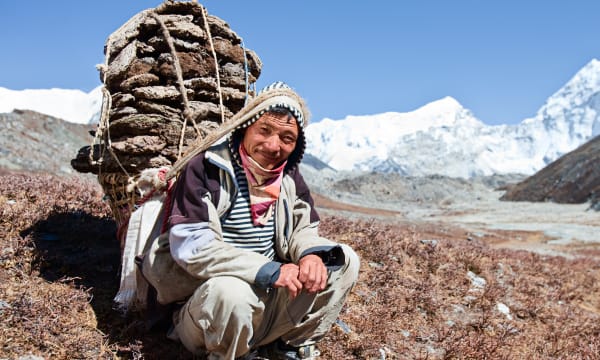 Sherpa with backpack in the mountains