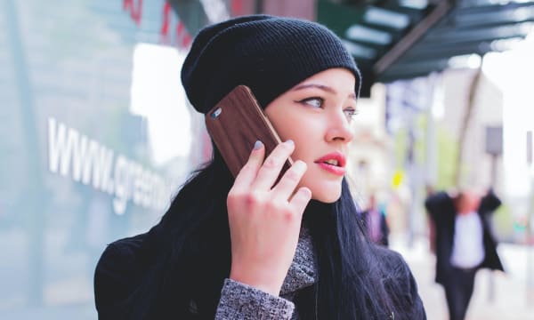 Woman in beanie hat on mobile phone