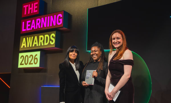Sophia Newman from VML Enterprise Solutions is pictured with two other individuals, holding a trophy from the LPI Awards