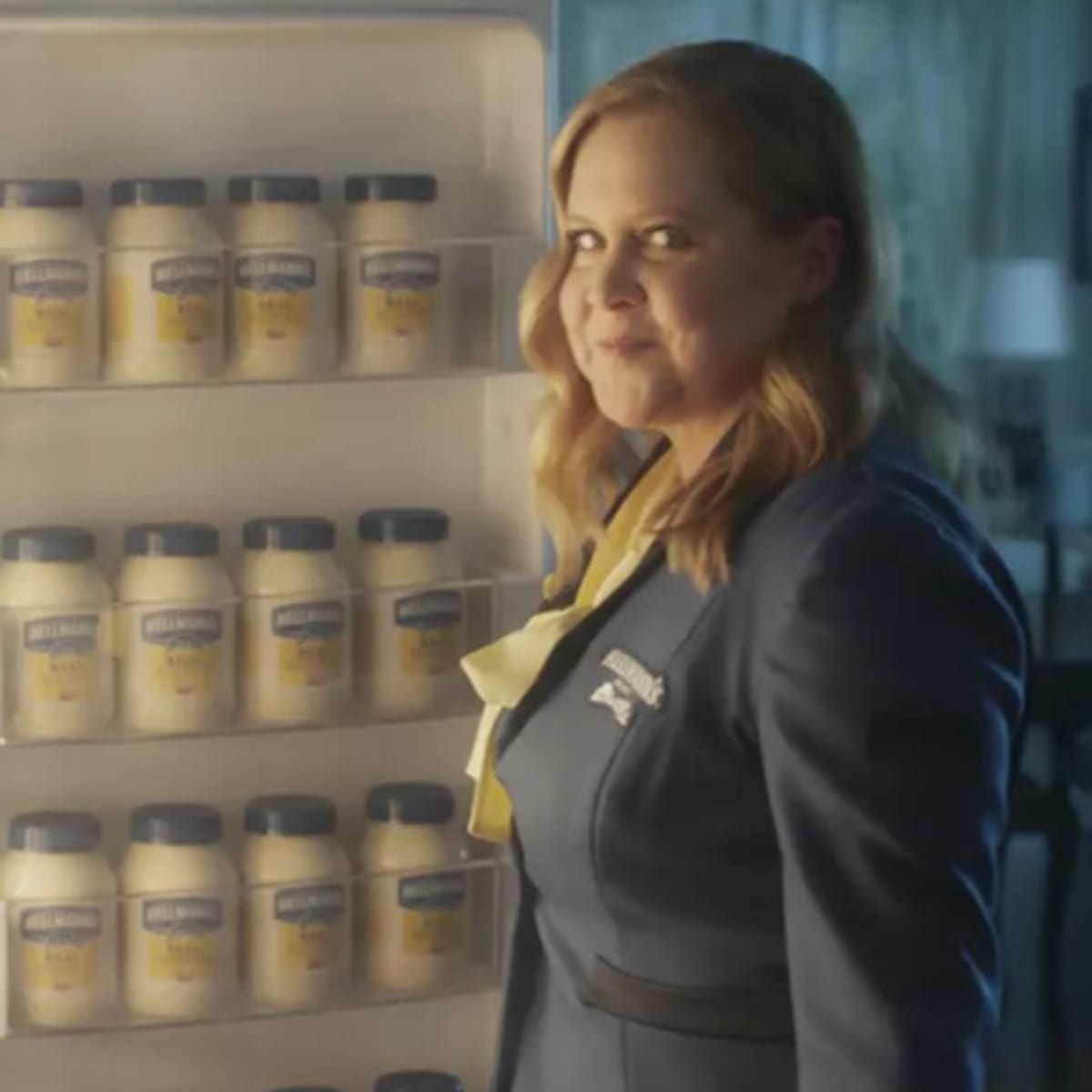 woman in front of open refrigerator filled with Hellmanns mayonaise