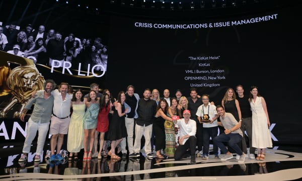 Group photo of VML and Burson on stage at the Cannes Lions Festival winning a Grand Prix Lion for "The KitKat Heist"