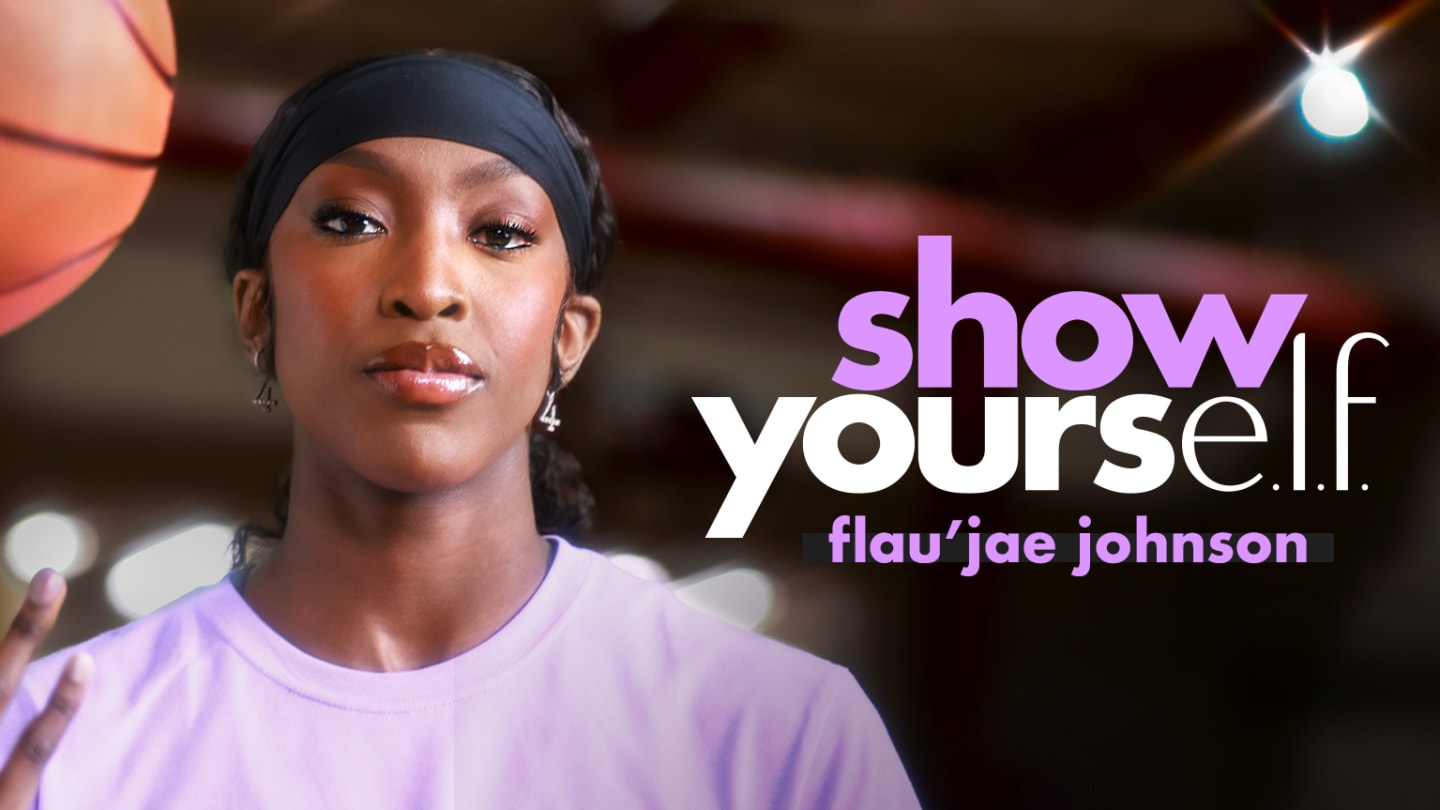 Basketball player and artist Flau'jae Johnson wearing a black headband and light purple t-shirt while spinning a basketball on her finger in a gymnasium. Text overlay on the right reads 'show your e.l.f.' and 'flau'jae johnson'.