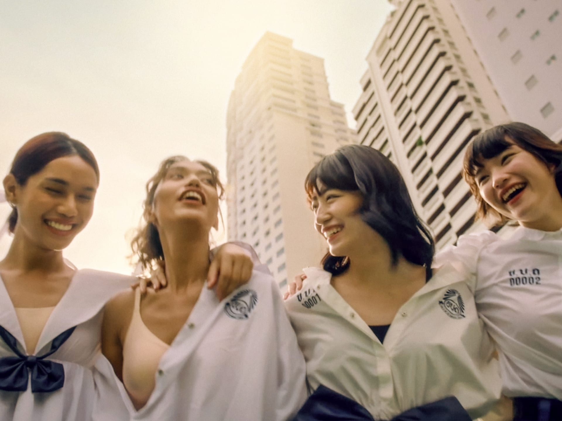 four women in front of a skyscraper skyline