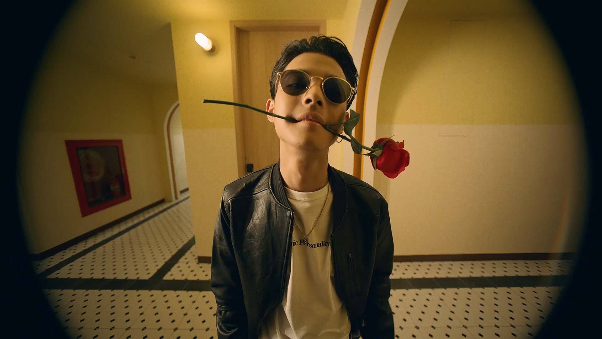 guy with red rose in his mouth