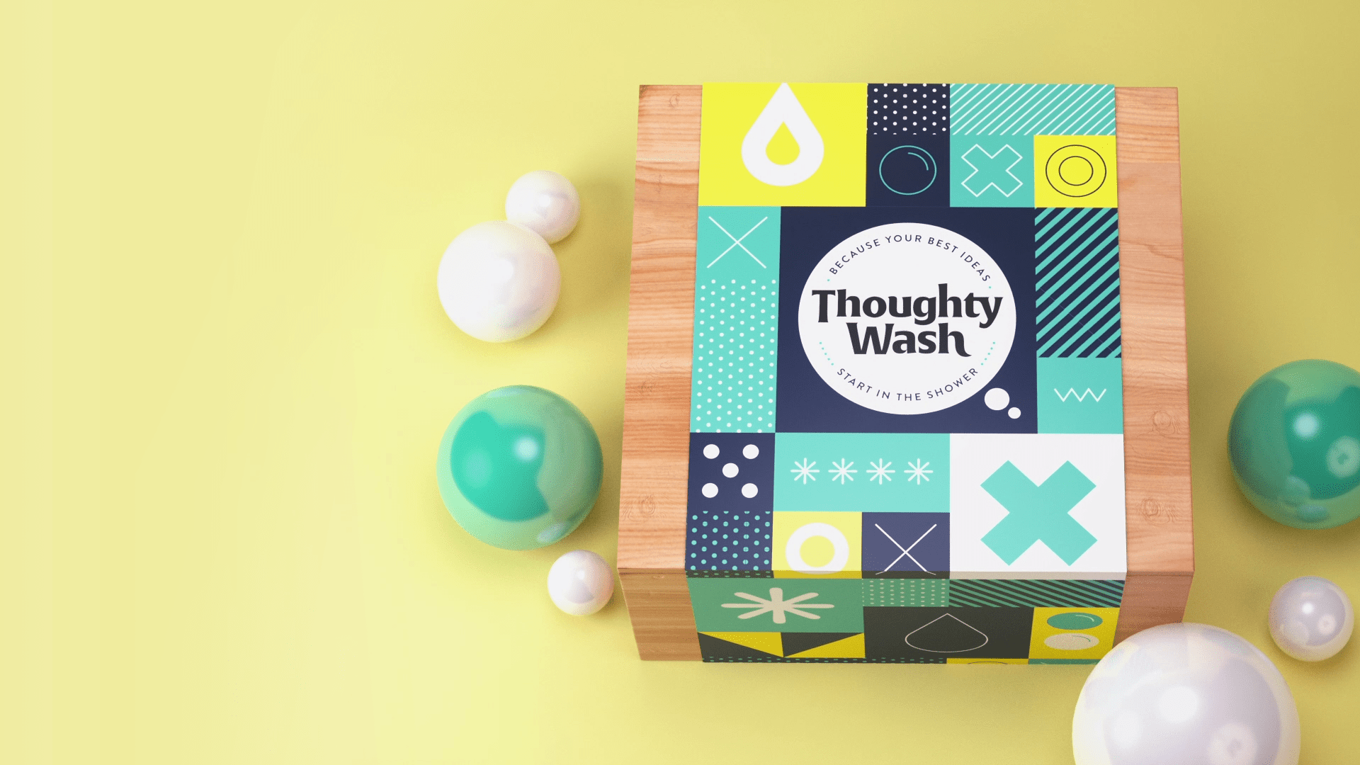 Yellow background. A square wooden box with a wrap around saying Thoughty Wash. Green and white baubles surround the box.