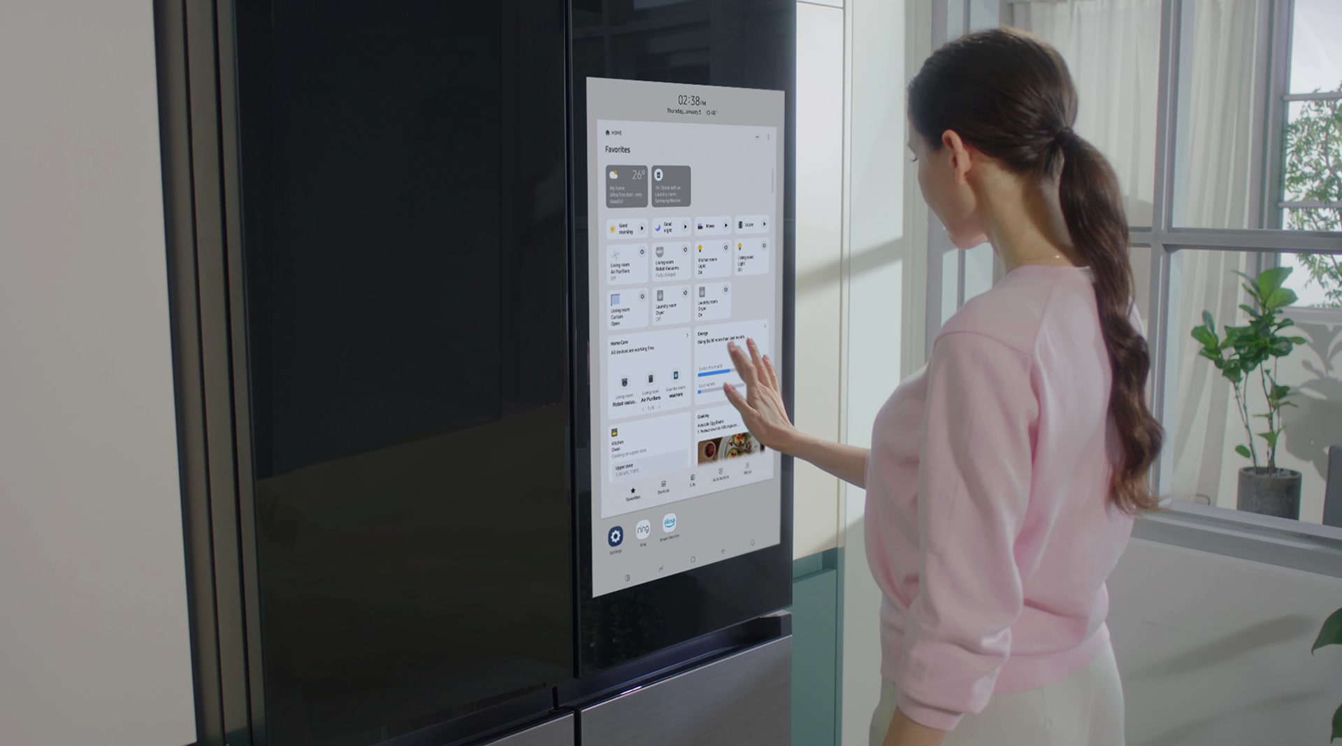 A woman with brown hair faces away from the camera touching a screen menu.