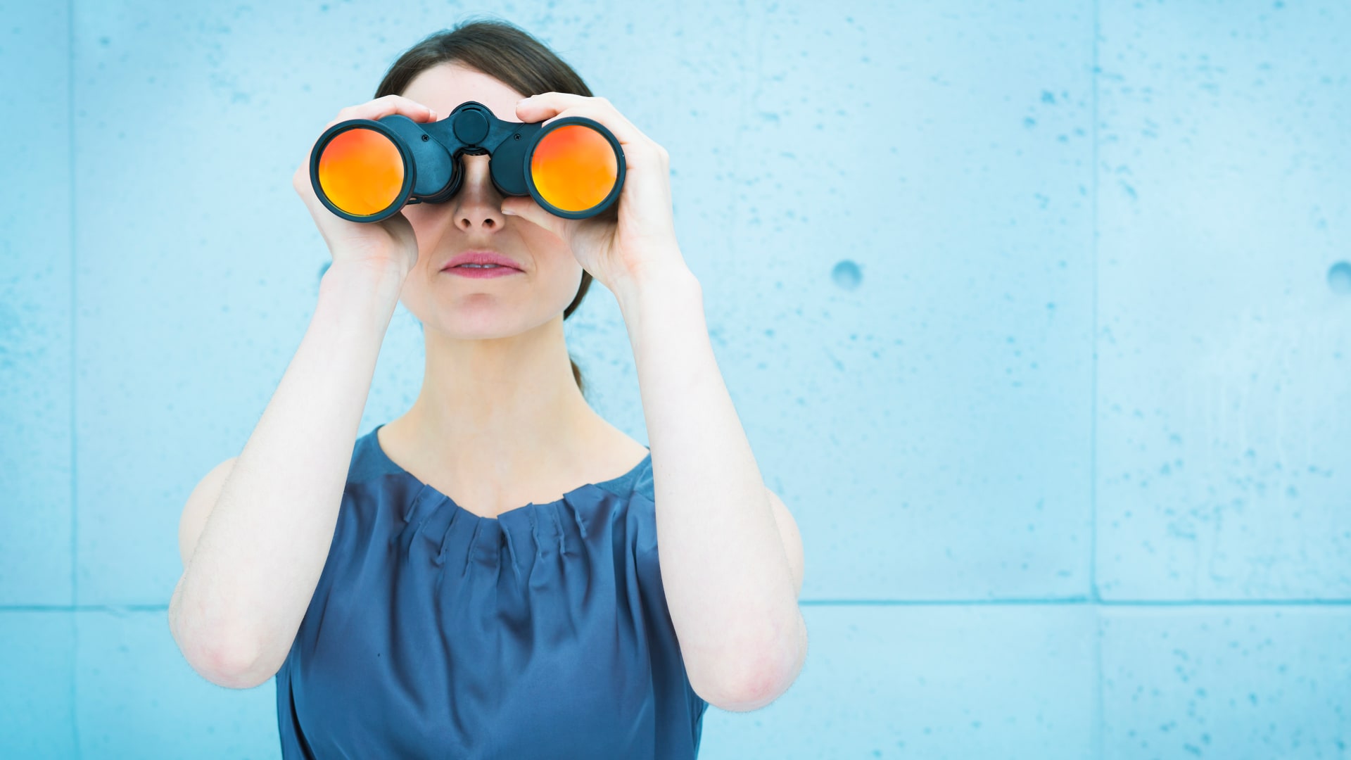 Woman looking through binoculars