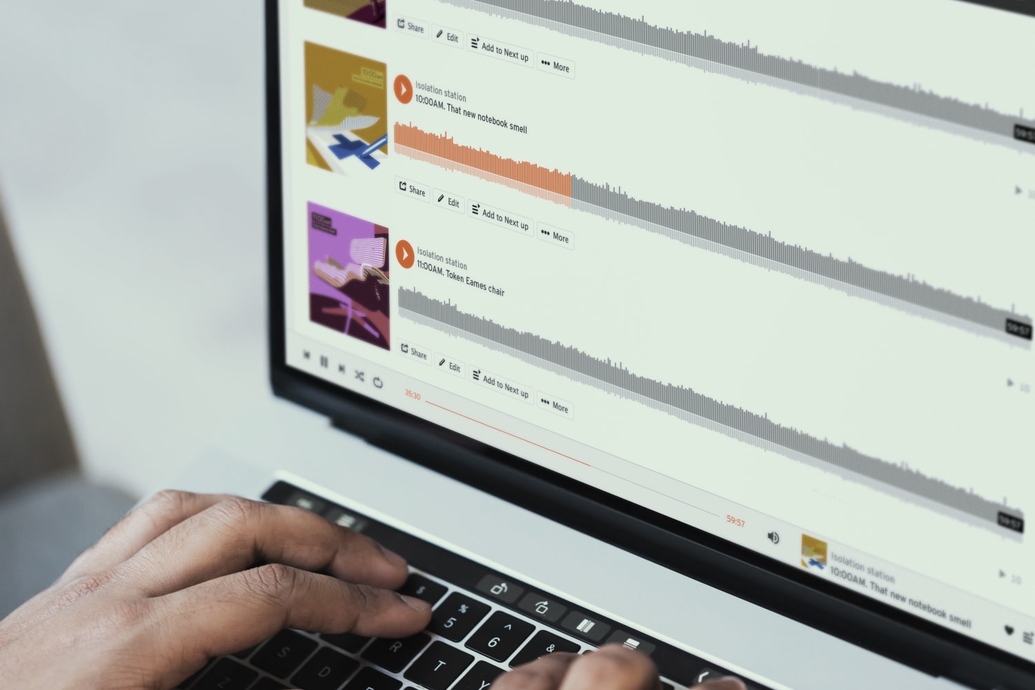Hands on a laptop with WT Isolation Station Playlist on the computer screen