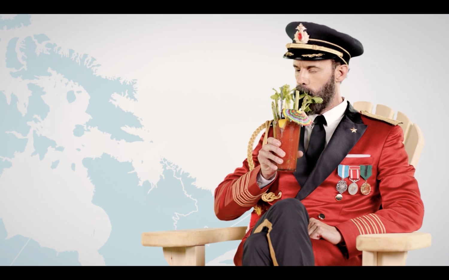 Captain Obvious sitting in Muskoka chair, sipping a caesar in front of a map of Canada.