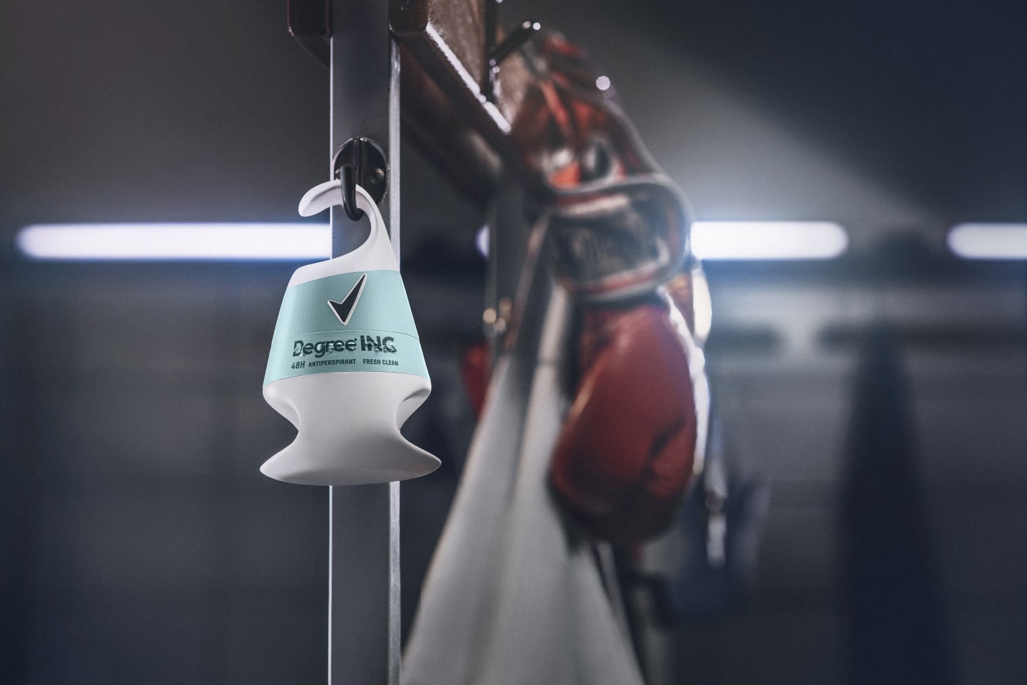 Deodorant with hook hanging in locker room with boxing gloves in the background