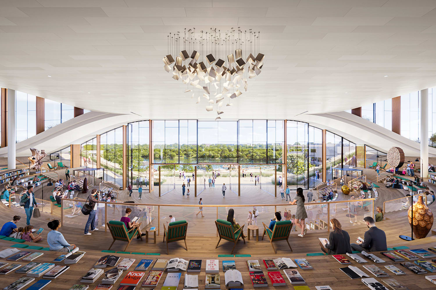 A wide open atrium with a silver, boxy chandelier. People are sitting in chairs and on steps with books scattered throughout, looking through a fully glass, see-through front wall beyond which a lake and full treeline can be seen.