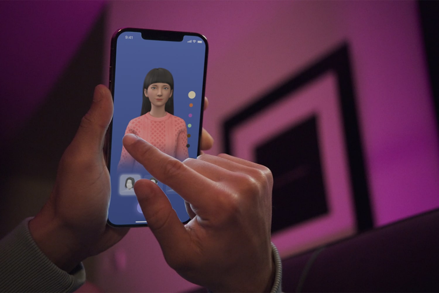 Two hands hold a smart phone with an avatar on the screen who has dark long hair and light skin. The right hand is touching the smart screen.