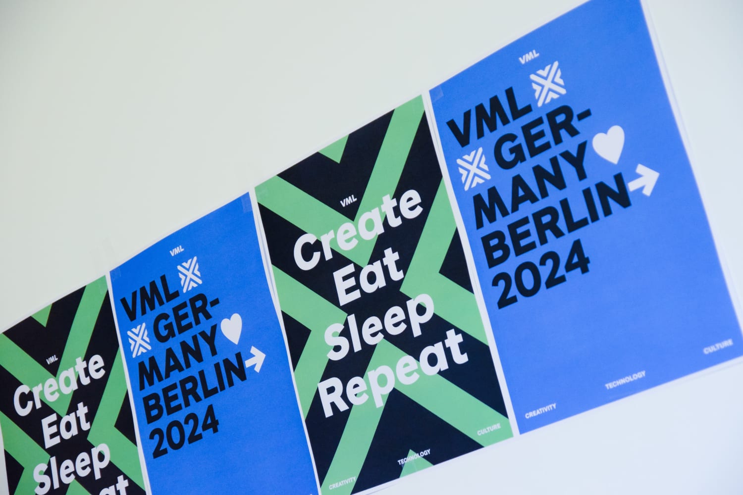 Image of posters on the wall with text "Create, eat, sleep, repeat" and "VML Germany Berlin 2024"