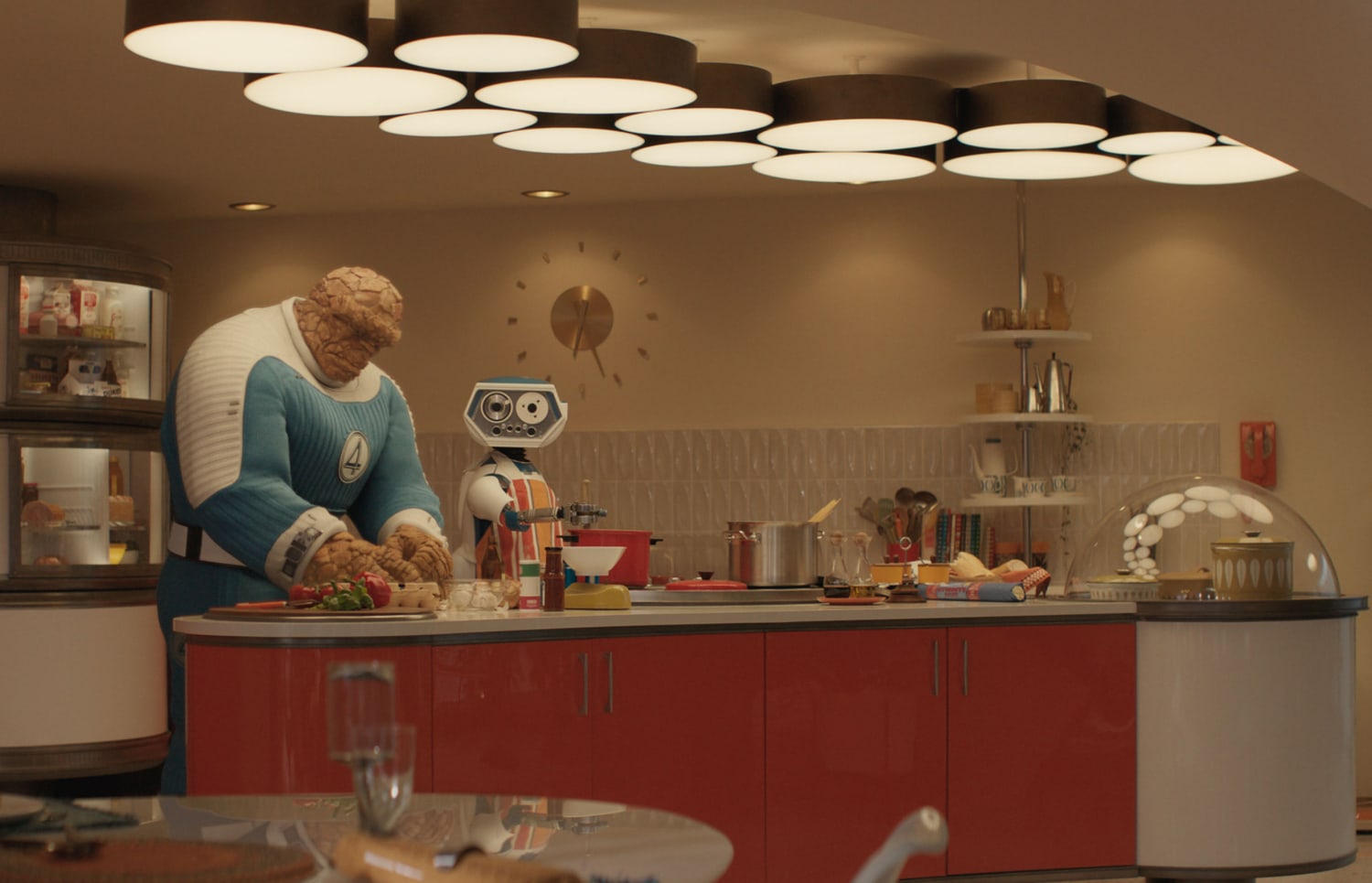 Scene from Marvel's Fantastic Four, 2025. The Thing and H.E.R.B.I.E the robot are cooking diner in a retro style kitchen.