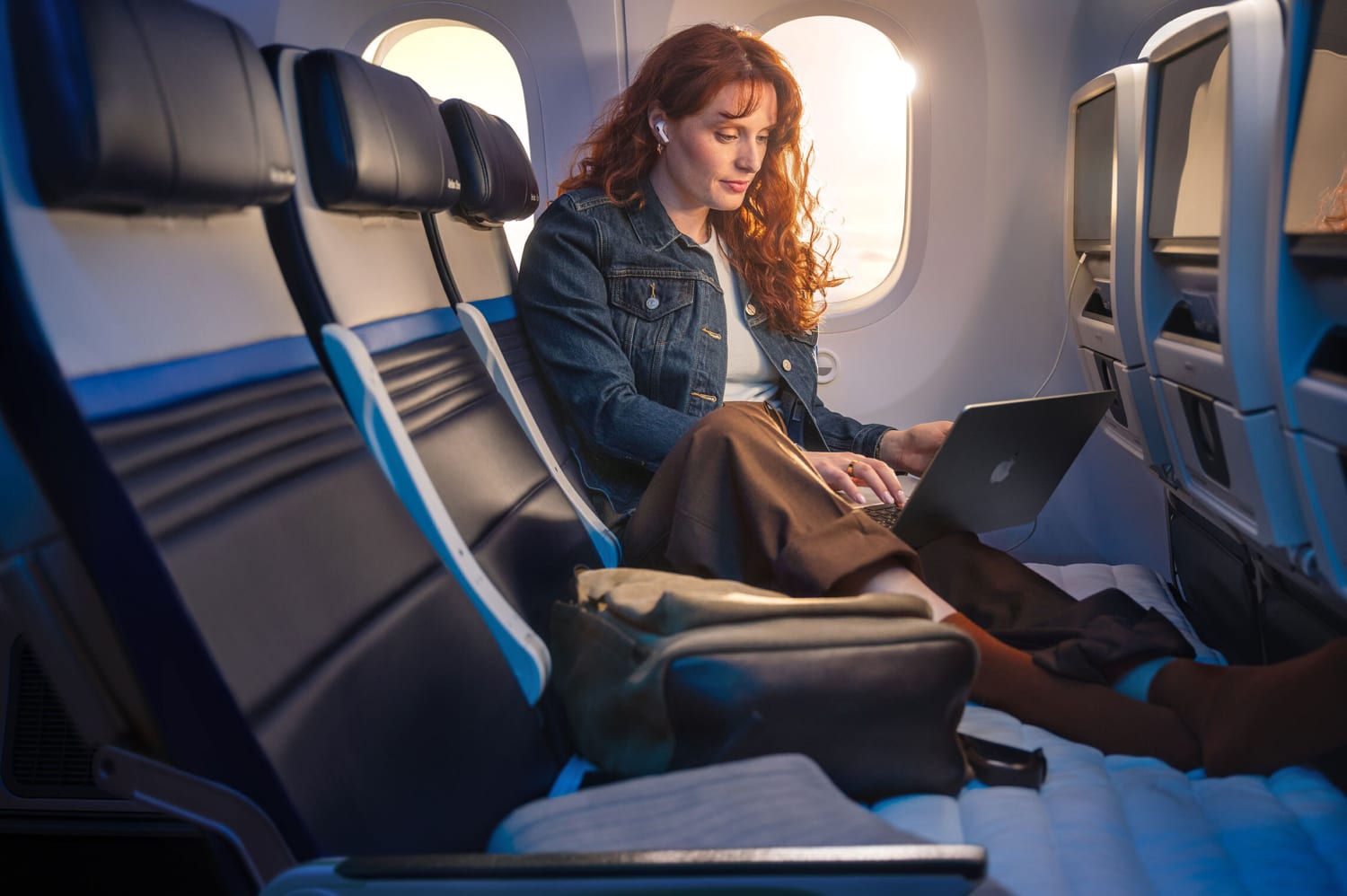United Airlines’ Relax Row transforms a standard row of three economy seats into a couch-like sleeping space. Courtesy of United Airlines