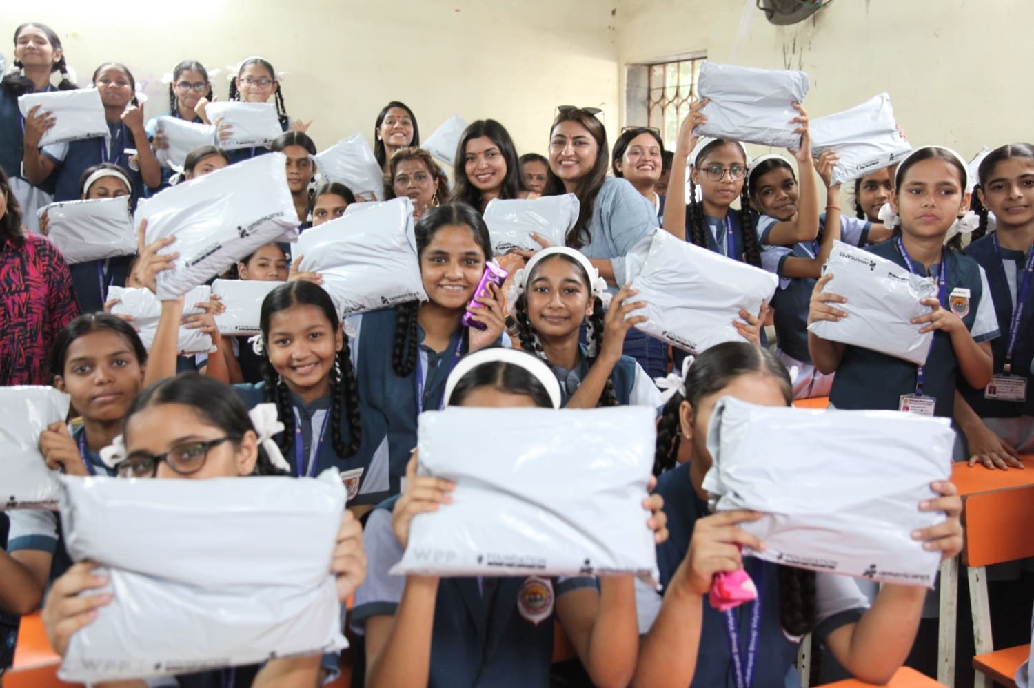 Community outreach initiative distributing sanitary pads to schoolgirls during VML Foundation Day