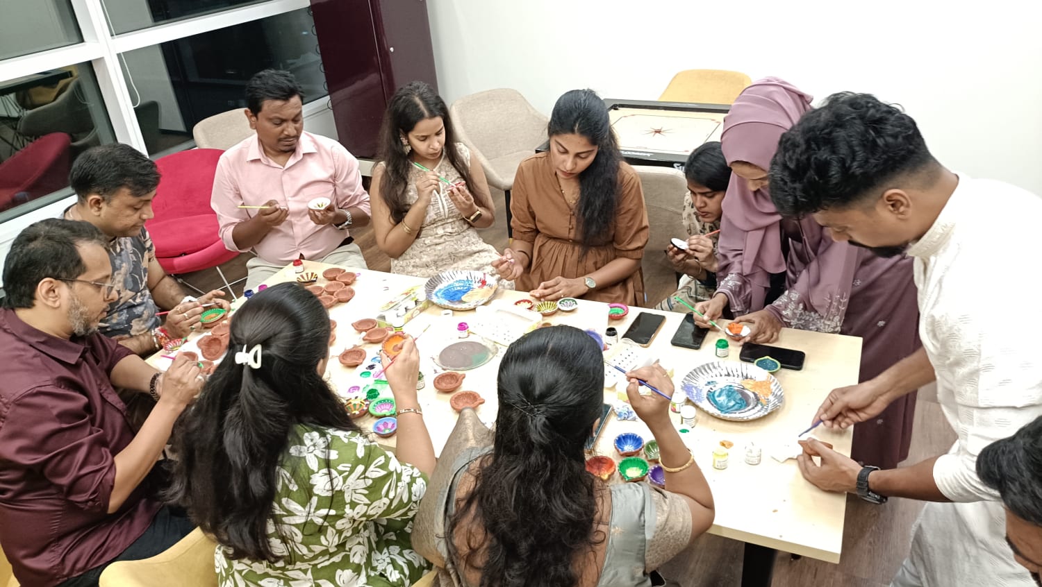 VML Enterprise Solutions Mumbai employees celebrating Diwali by painting diyas.
