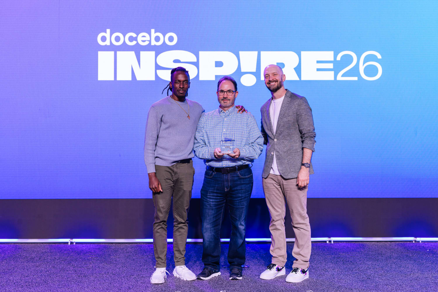 Rich Schmick and Marve Afolayan from VML accepting the Best Employee/Talent Development Program award for the Open Everydai initiative at the Docebo Inspire 2026 Conference in Miami.