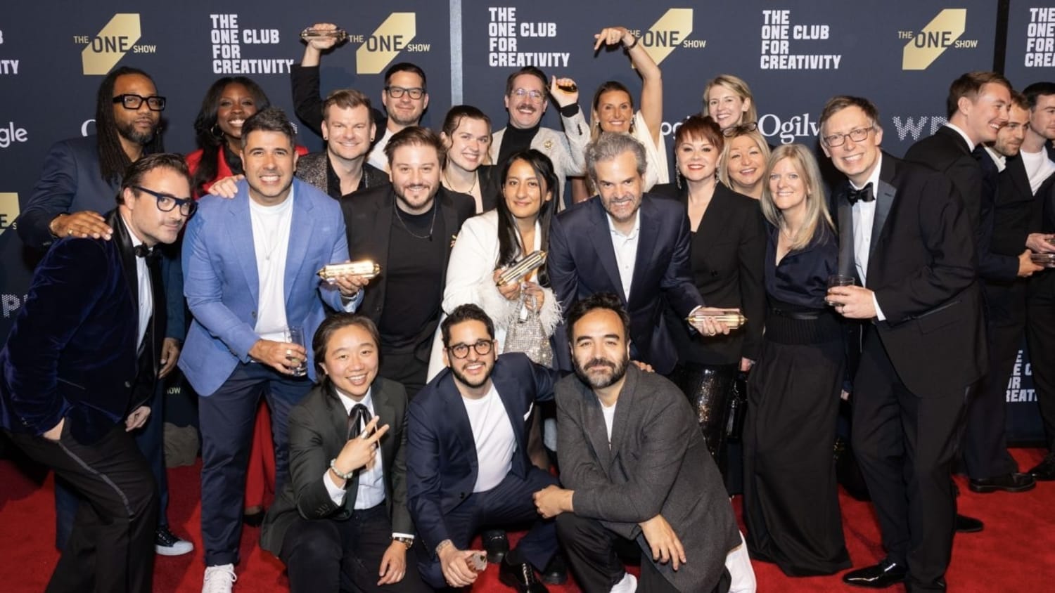 This image shows a group of VMLers posing on a red carpet at an event for "The One Show Awards" by "The One Club for Creativity."