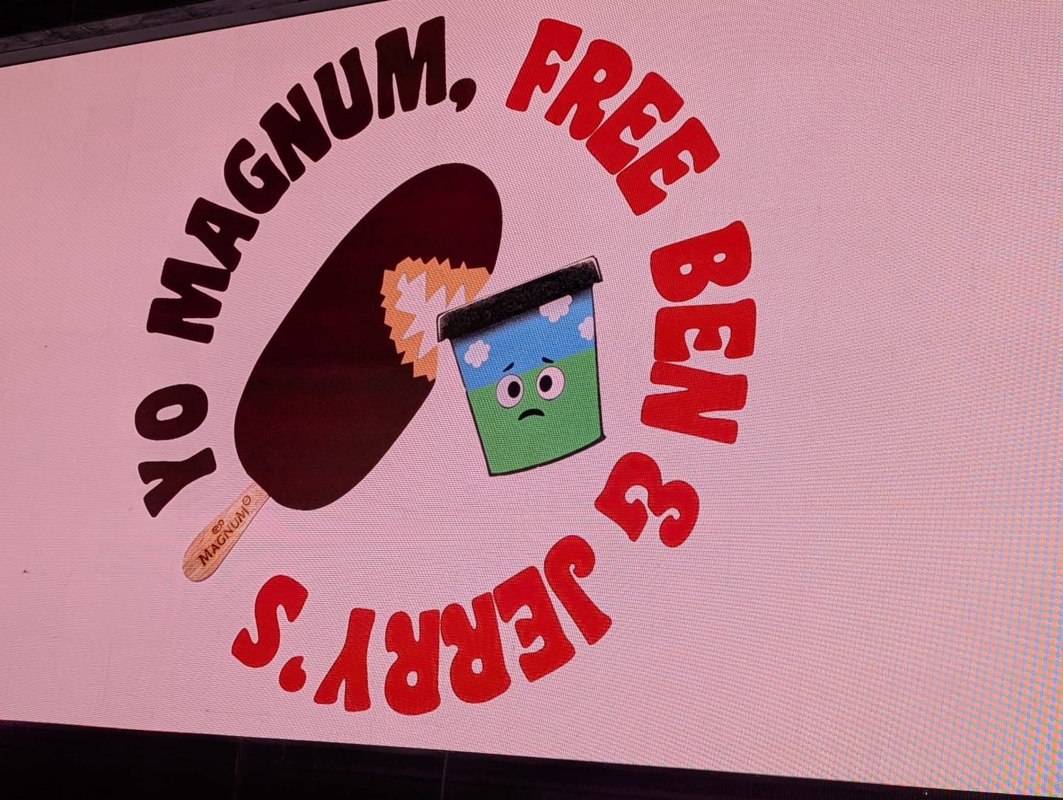 Cartoon graphic of an ice cream chomping into a tub pf Ben and Jerrys with the slogan "Yo Magnum, Free Ben &amp; Jerry's"