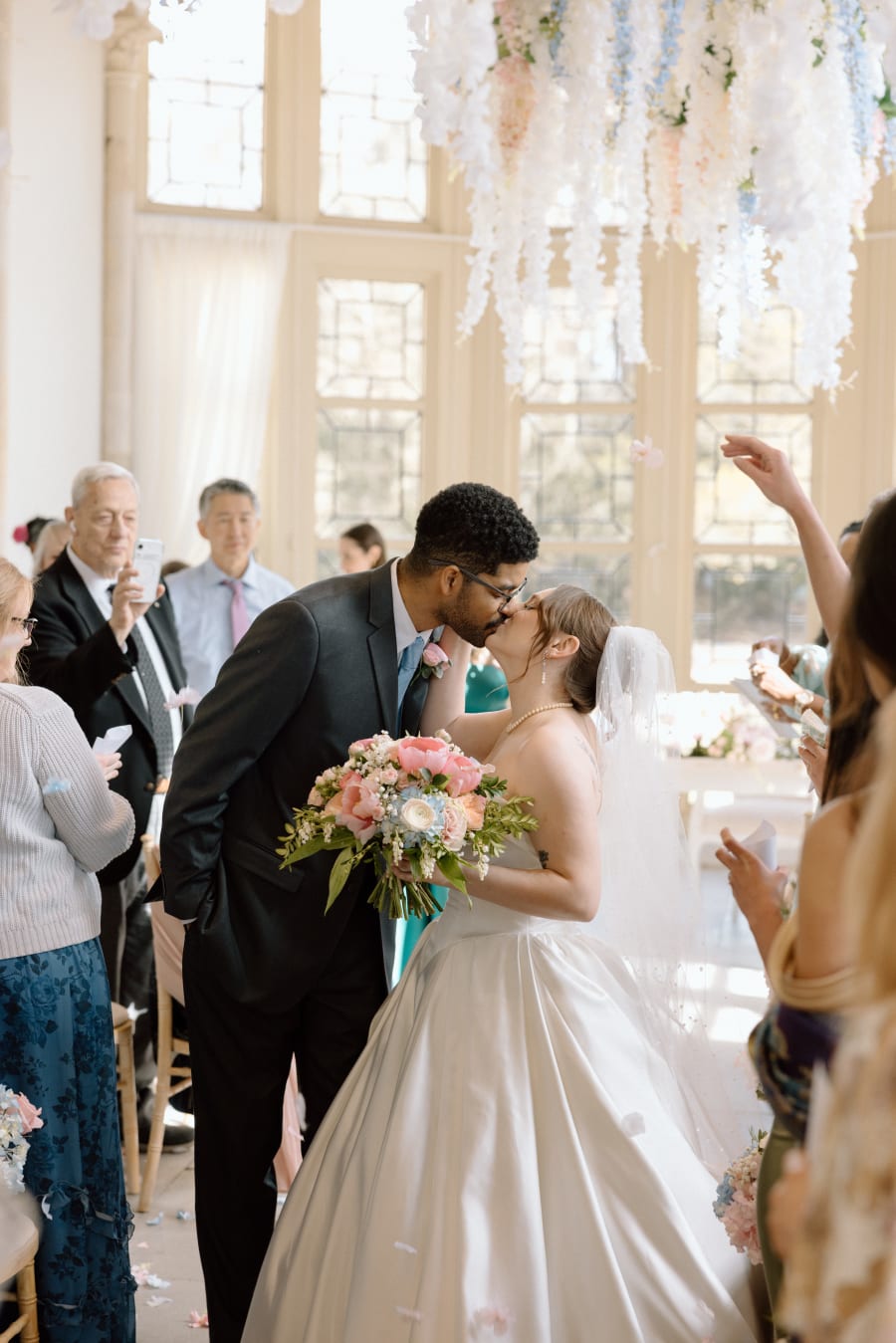 The first kiss as their guests throw confetti, Highcliffe Castle, Christchurch